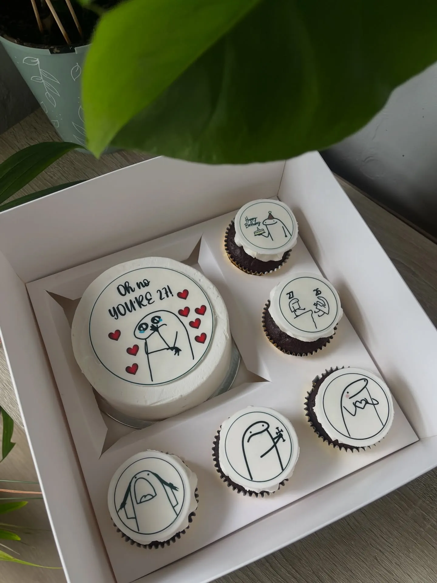 Bento cake and five cupcakes with hand-drawn meme toppers in a gift box